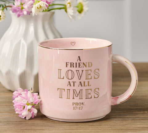 Inscribed Pink Marbled Friendship Ceramic Coffee Mug with Flowers in Vase in Background - Close-up