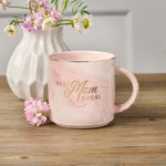 Best Mom Ever Pink Marbled Ceramic Coffee Mug with Flowers in White Vase in Background 