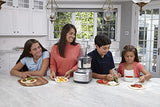Family in bright colored kitchen with sunny windows gathered around counter preparing meal with modern 13-cup food processor.